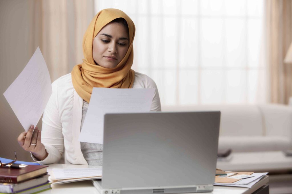 Mixed Race Woman In Hijab Looking At Paperwork 149615431 5b1ac25ceb97de0036e5aebc.jpg