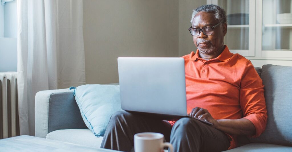 Misinformation, AI & health: Poll reveals older adults’ worries Older Man Sitting On Couch With Computer.jpg