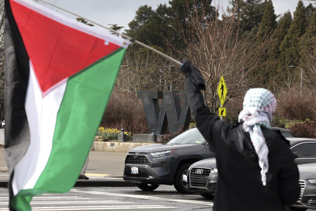 University of Washington Slams Activists Who Occupied Building, Set Fires Uw protester palestinian flag.jpg
