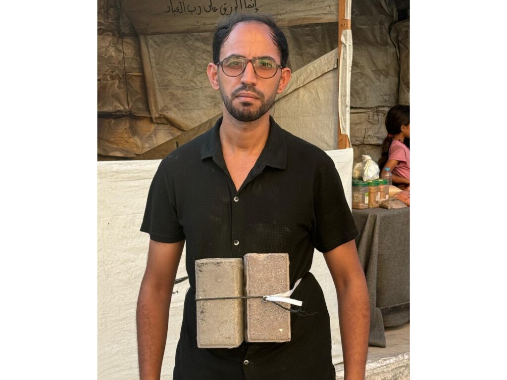 Hady walks with two bricks tied to his stomach hoping it would help him block out the hunger. image.jpeg