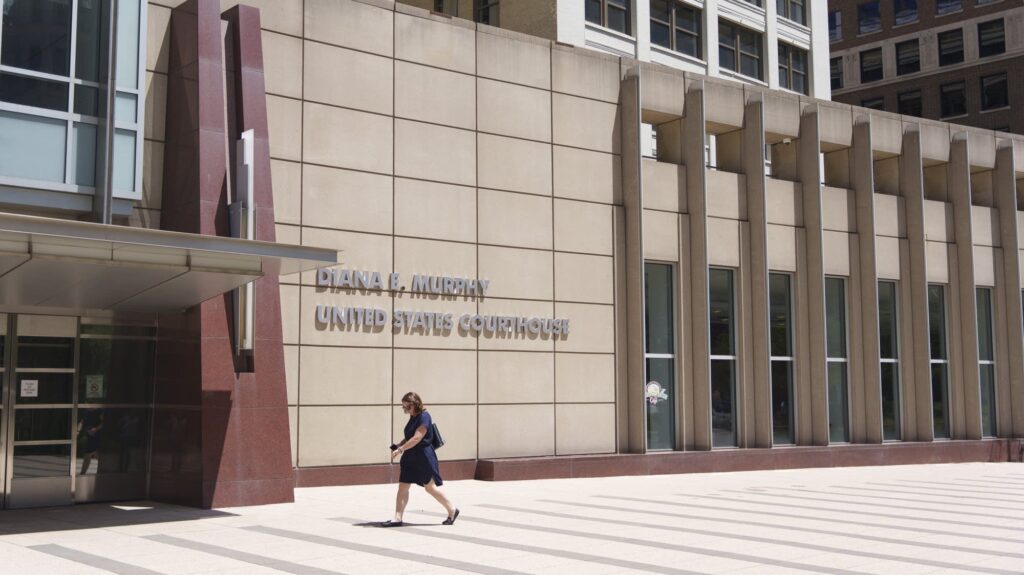 023a26 20240607 a woman walks into a building 2000.jpg