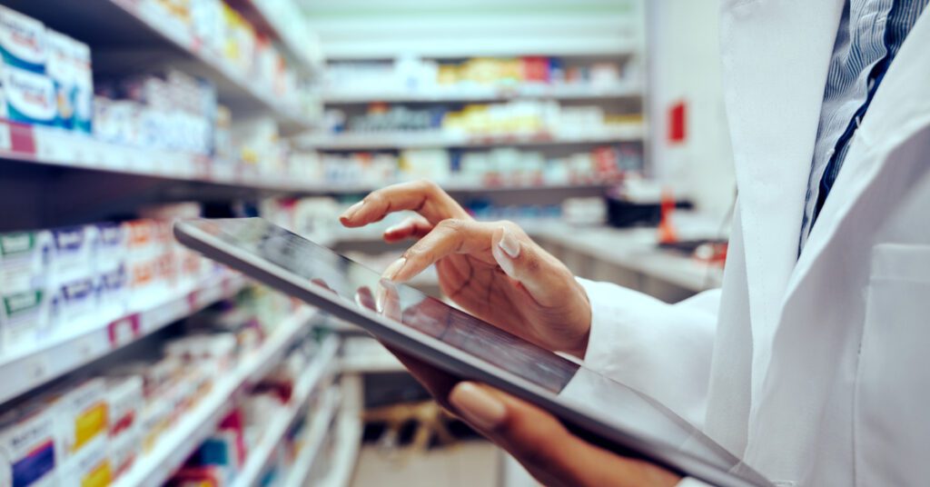 2257430 closeup of hands of young female pharmacist checking inventory in medical store using digita.jpeg