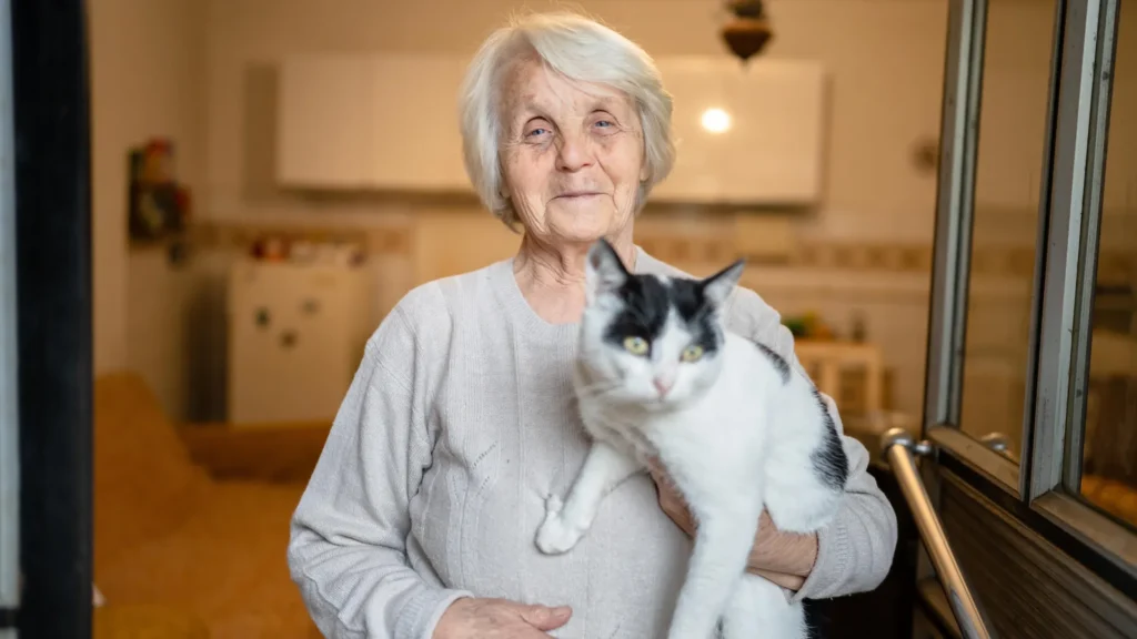 How cats with dementia could help crack the Alzheimer’s puzzle Elderly woman with cat.webp.webp