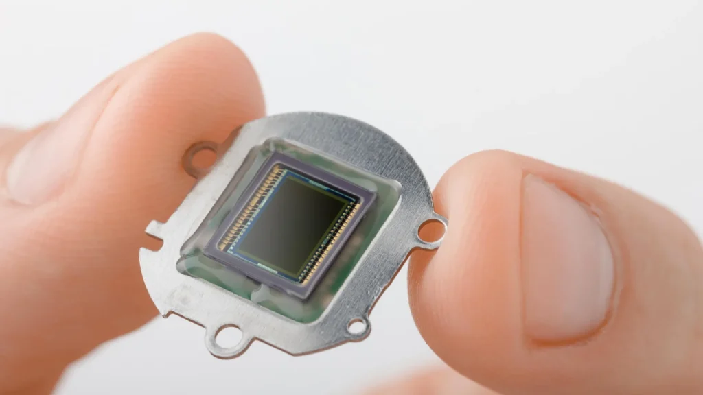 Tiny chip could unlock gamma ray lasers, cure cancer, and explore the multiverse Holding small electronics chip.webp.webp
