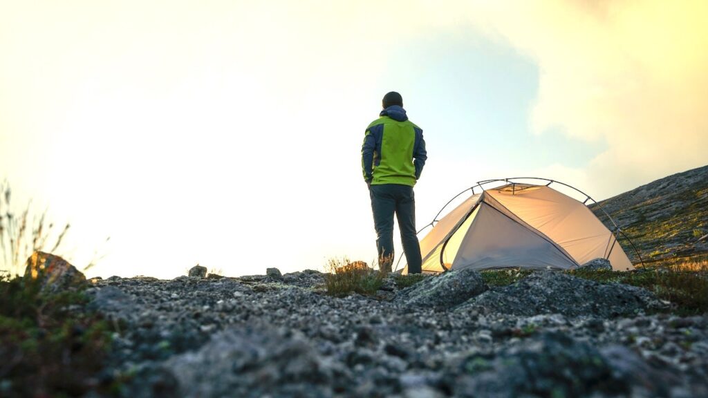 Man camping outdoors with tent.jpg