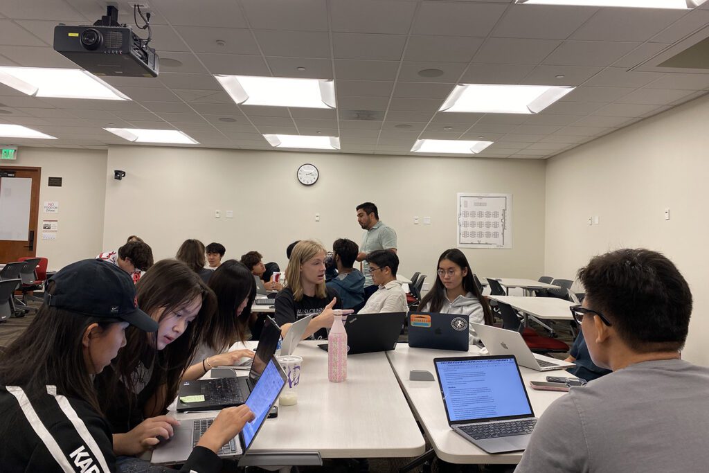 Biology students explore hot-button science topics in the news Students chatting.jpg