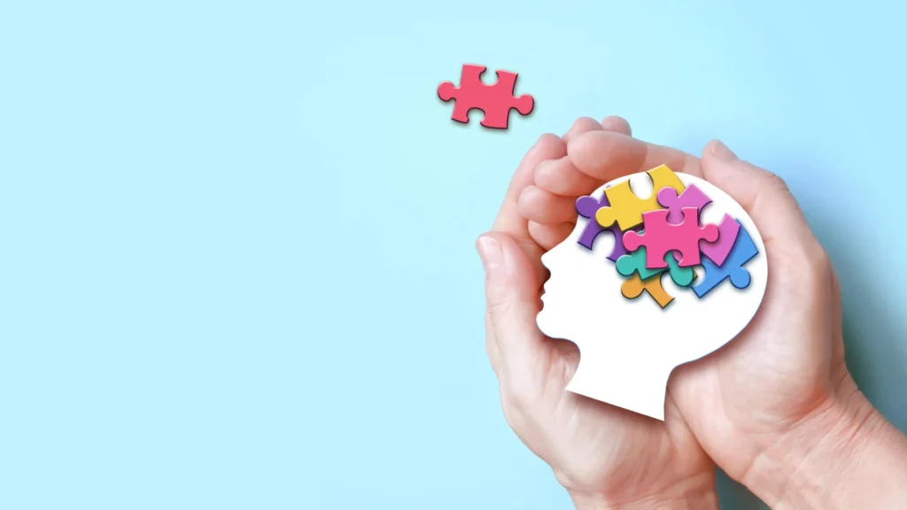 Autism spectrum disorder hands holding brain puzzle.webp.webp