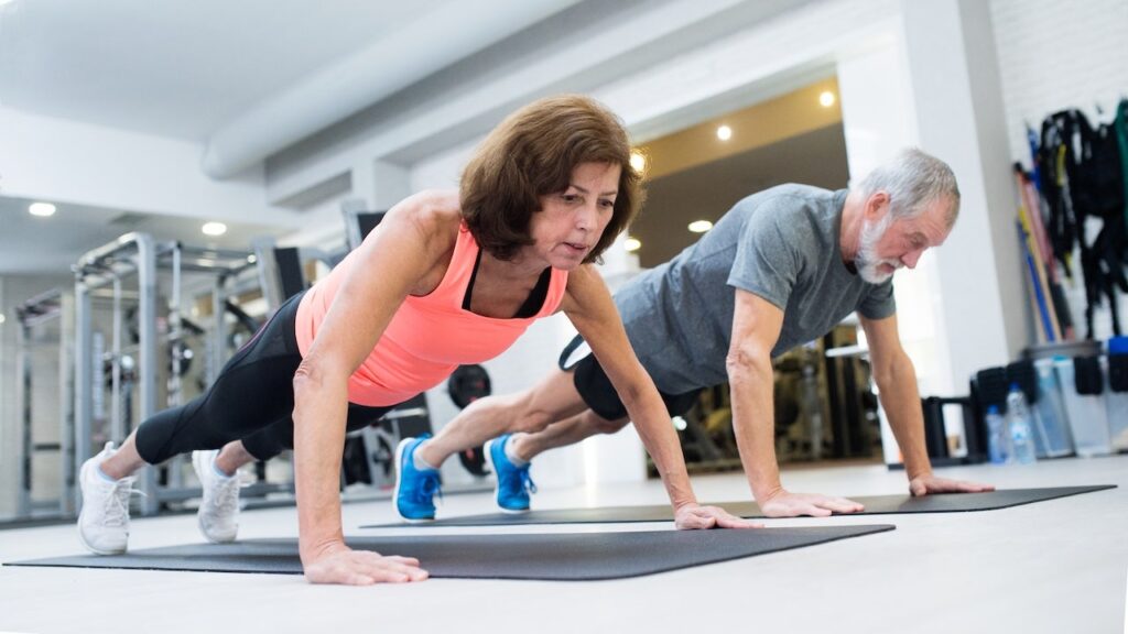 6 pillars of strength training for older adults from NYC fitness expert Older couple doing push ups.jpg