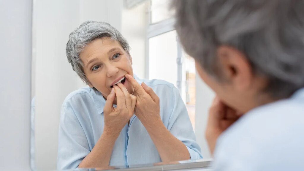 Older woman flossing.jpg
