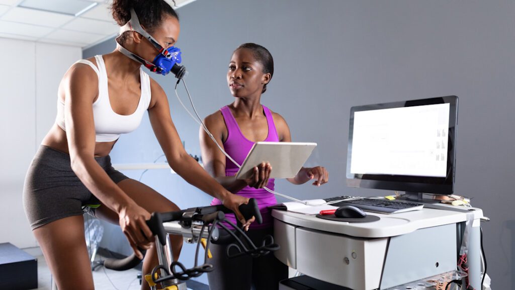 Horizontal Front view of an African American athletic woman doing a fitness test using a mask connec.jpeg
